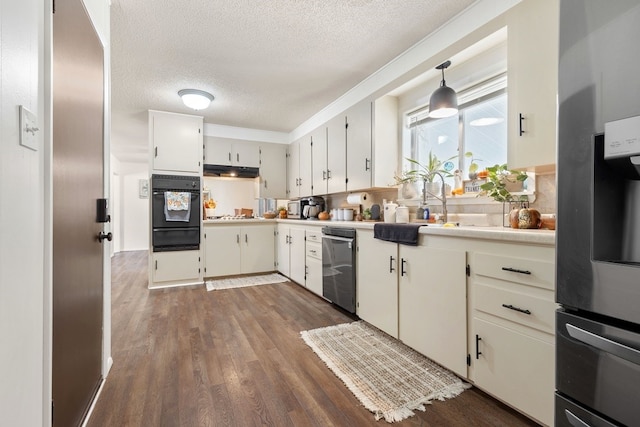 kitchen with pendant lighting, a textured ceiling, white cabinetry, stainless steel appliances, and dark hardwood / wood-style flooring