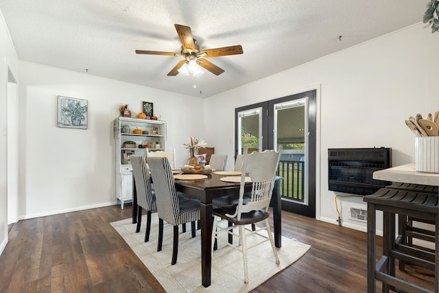 dining room featuring ceiling fan, heating unit, dark wood-type flooring, and a textured ceiling