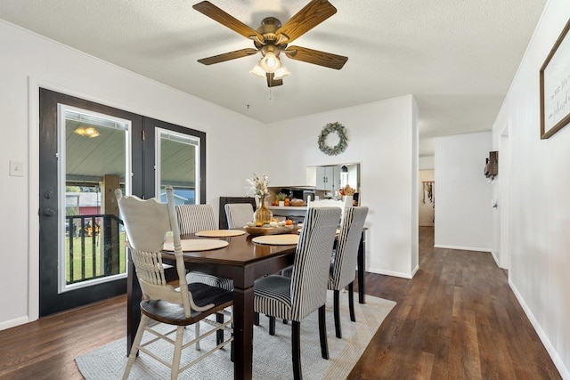 dining area with dark wood-type flooring, ceiling fan, and a textured ceiling