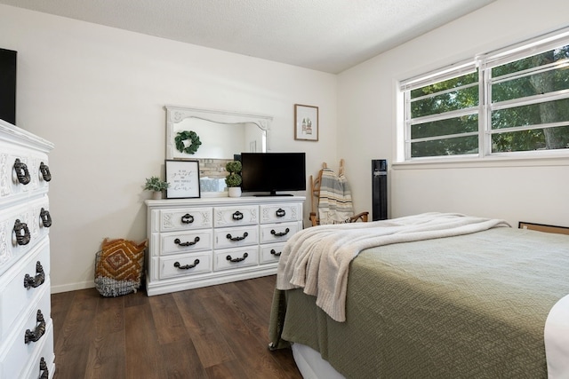 bedroom featuring dark wood-type flooring and a textured ceiling