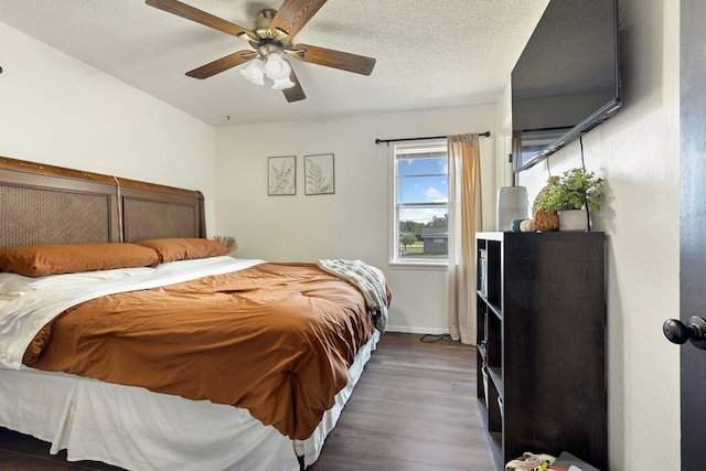 bedroom featuring dark hardwood / wood-style floors, a textured ceiling, and ceiling fan