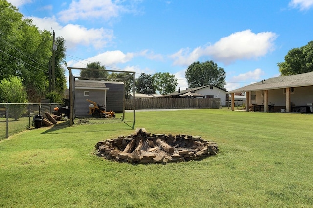 view of yard with a storage unit and a fire pit