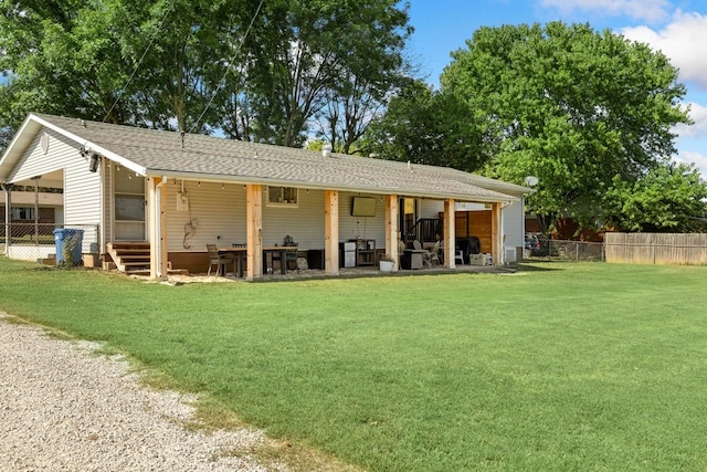 rear view of property with a lawn