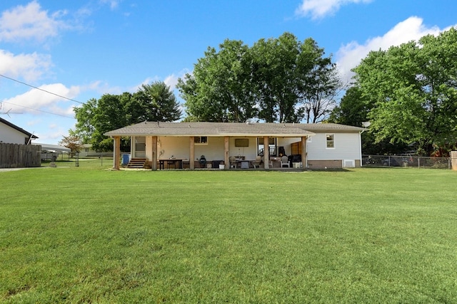 rear view of property featuring a yard