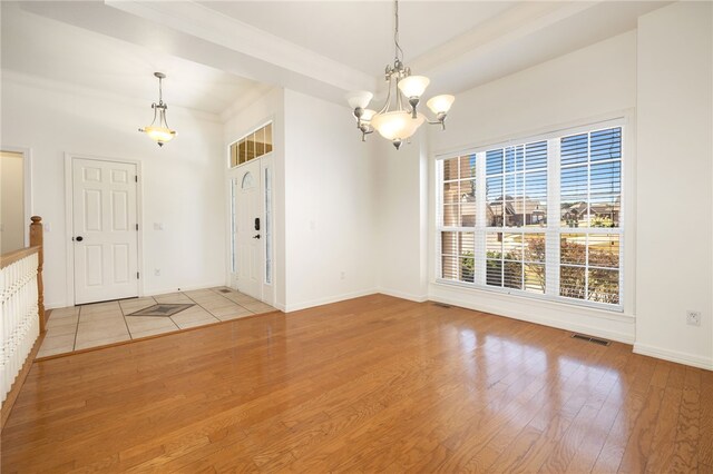 interior space with light hardwood / wood-style flooring and a notable chandelier