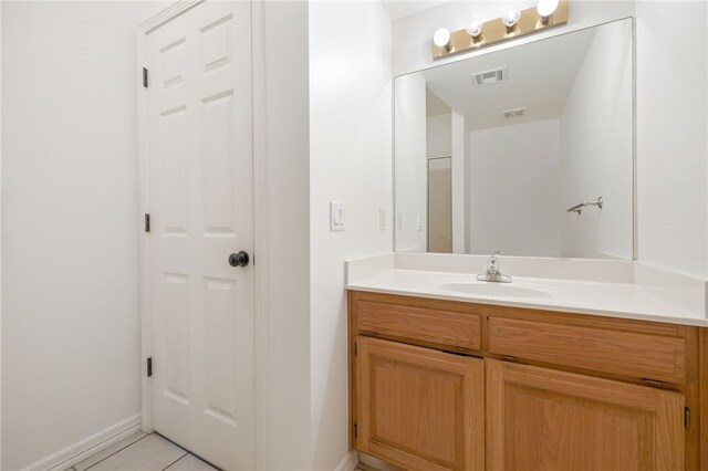 bathroom with tile patterned floors and vanity