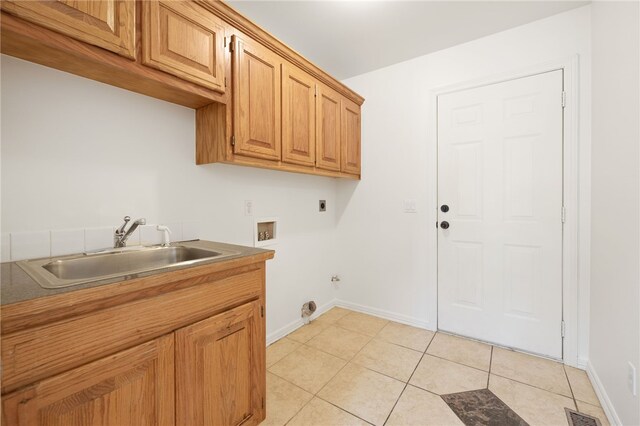 laundry room with sink, cabinets, hookup for an electric dryer, hookup for a washing machine, and light tile patterned floors