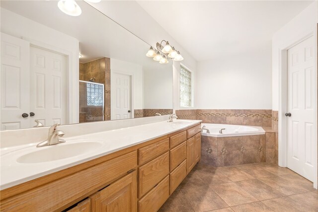 bathroom with plus walk in shower, vanity, and tile patterned flooring