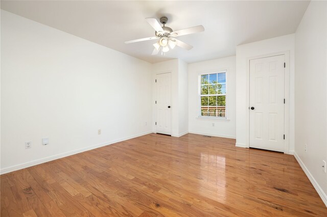 spare room featuring ceiling fan and light hardwood / wood-style flooring