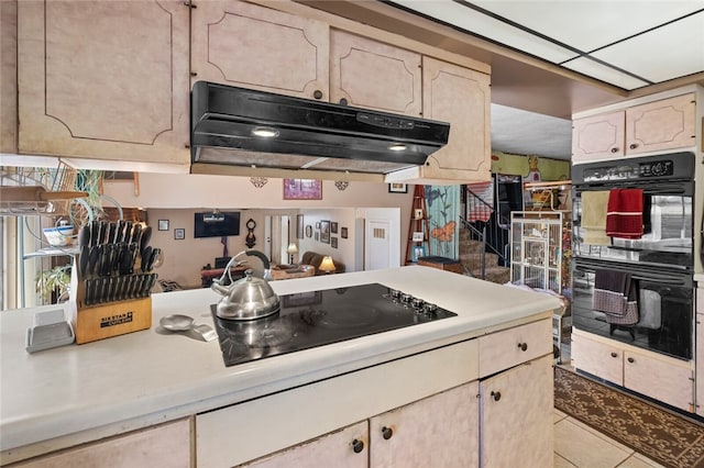 kitchen featuring light tile patterned flooring and black appliances