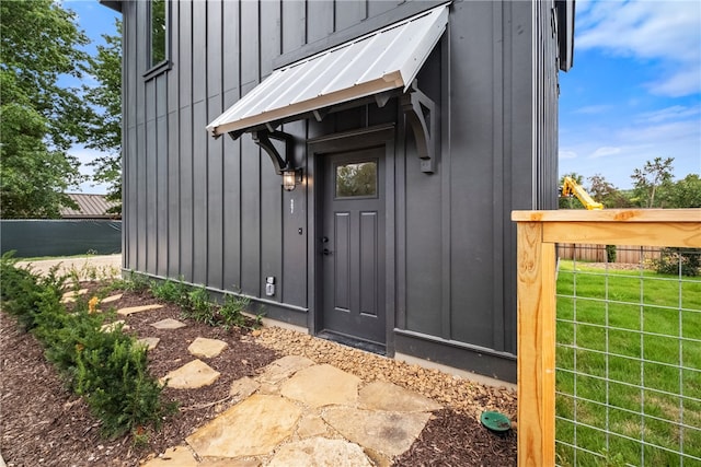 doorway to property featuring a lawn