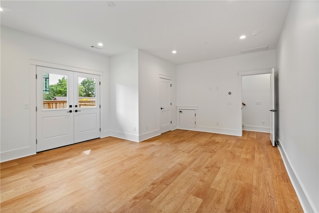 foyer featuring light wood-type flooring and french doors