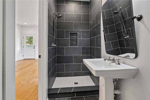 bathroom featuring tiled shower and hardwood / wood-style floors