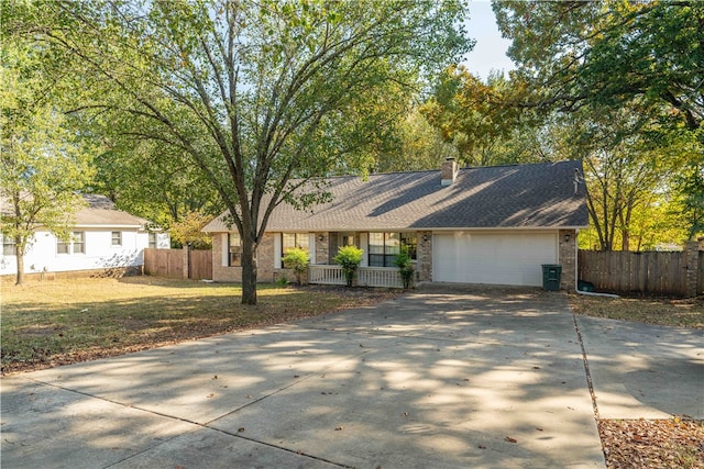 ranch-style home with a front lawn, a porch, and a garage