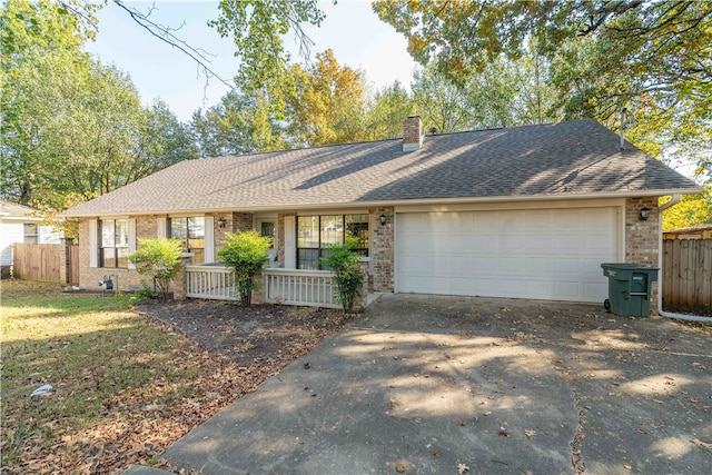 ranch-style home with a garage and covered porch