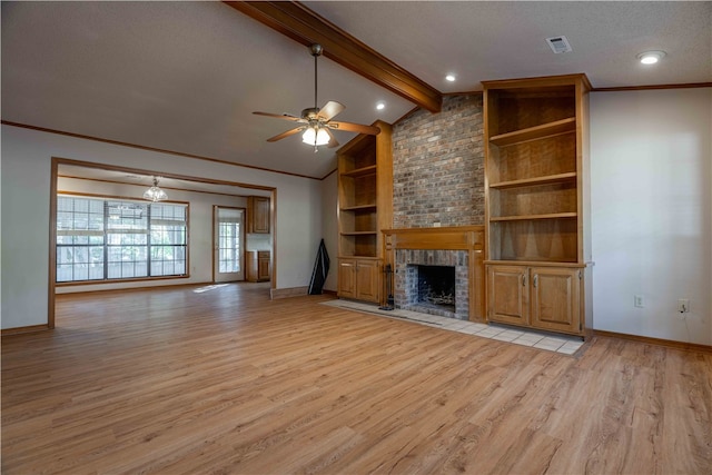 unfurnished living room with a brick fireplace, crown molding, lofted ceiling with beams, and light wood-type flooring