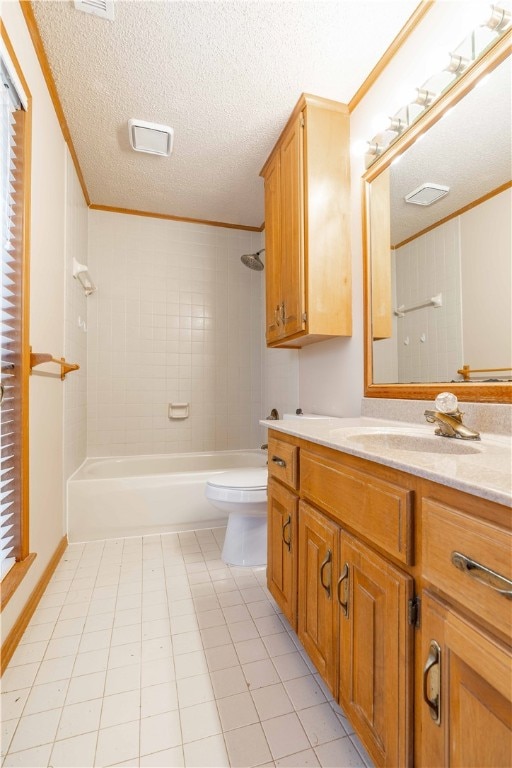 full bathroom with tiled shower / bath, vanity, a textured ceiling, crown molding, and toilet