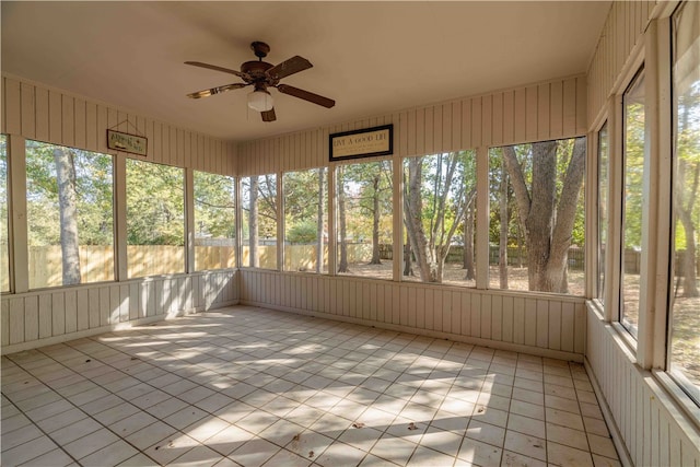 unfurnished sunroom with ceiling fan