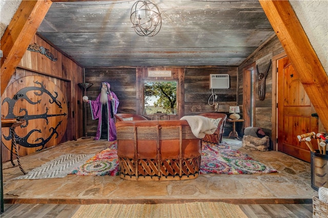 interior space featuring wood walls, a wall mounted AC, hardwood / wood-style floors, a chandelier, and lofted ceiling