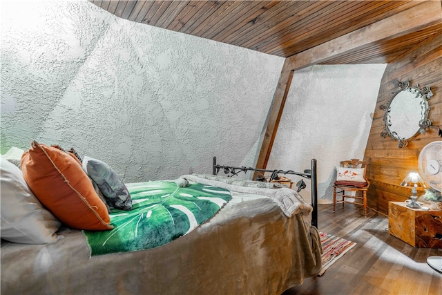 bedroom featuring wood walls, dark wood-type flooring, and wooden ceiling