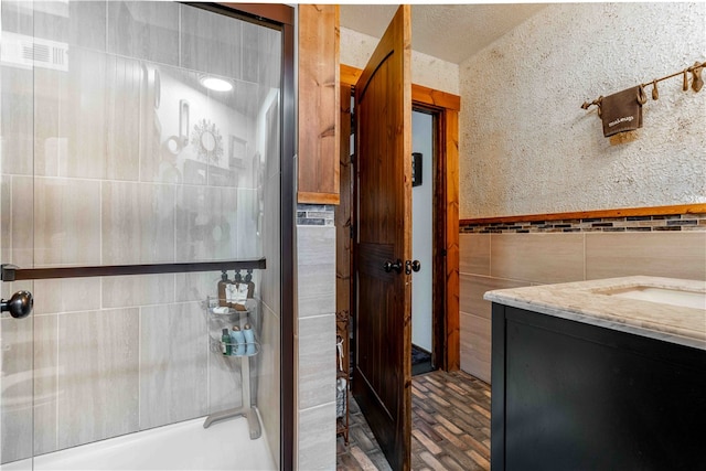 bathroom with vanity, tile walls, and bathing tub / shower combination