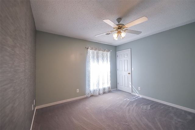 spare room featuring ceiling fan, a textured ceiling, and carpet floors