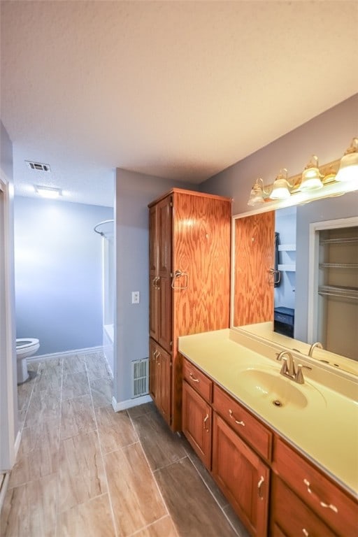 full bathroom with shower / bathing tub combination, vanity, and toilet