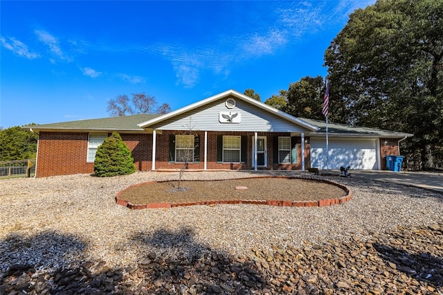 single story home featuring covered porch and a garage