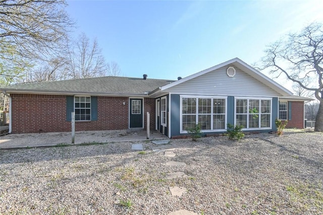 1 Hartlepool Dr, Bella Vista, AR 72715 - view of front of property featuring brick siding, a patio area, and roof with shingles