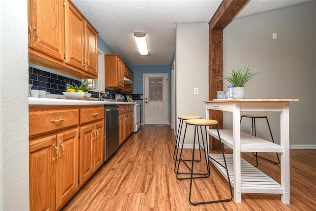 1 Hartlepool Dr, Bella Vista, AR 72715 - kitchen with stainless steel dishwasher, white stove, light countertops, and light wood-type flooring