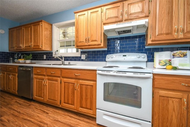 1 Hartlepool Dr, Bella Vista, AR 72715 - kitchen featuring stainless steel dishwasher, under cabinet range hood, electric stove, and light countertops