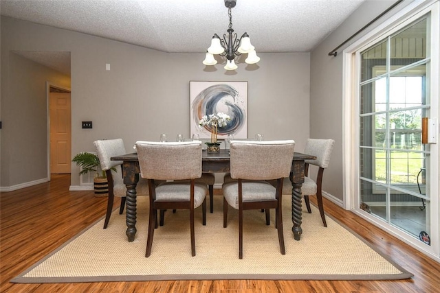 1 Hartlepool Dr, Bella Vista, AR 72715 - dining space with baseboards, an inviting chandelier, wood finished floors, and a textured ceiling