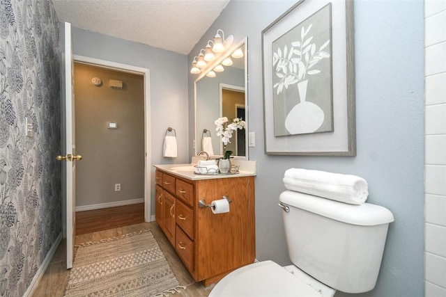 1 Hartlepool Dr, Bella Vista, AR 72715 - bathroom with toilet, a textured ceiling, wood finished floors, and vanity