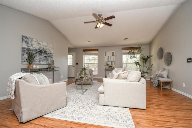 1 Hartlepool Dr, Bella Vista, AR 72715 - living area with visible vents, baseboards, a ceiling fan, light wood-style floors, and vaulted ceiling