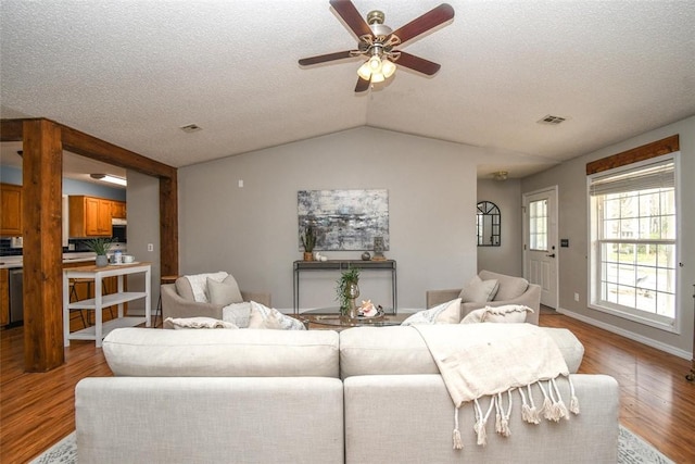 1 Hartlepool Dr, Bella Vista, AR 72715 - living area with visible vents, light wood-type flooring, a ceiling fan, a textured ceiling, and lofted ceiling