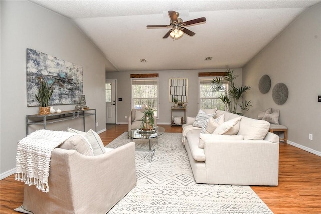 1 Hartlepool Dr, Bella Vista, AR 72715 - living area featuring visible vents, baseboards, a ceiling fan, wood finished floors, and lofted ceiling
