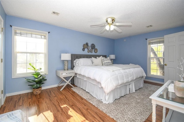 1 Hartlepool Dr, Bella Vista, AR 72715 - bedroom with visible vents, baseboards, wood finished floors, and a textured ceiling