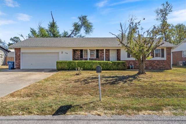 single story home with a front yard, a garage, and central AC unit