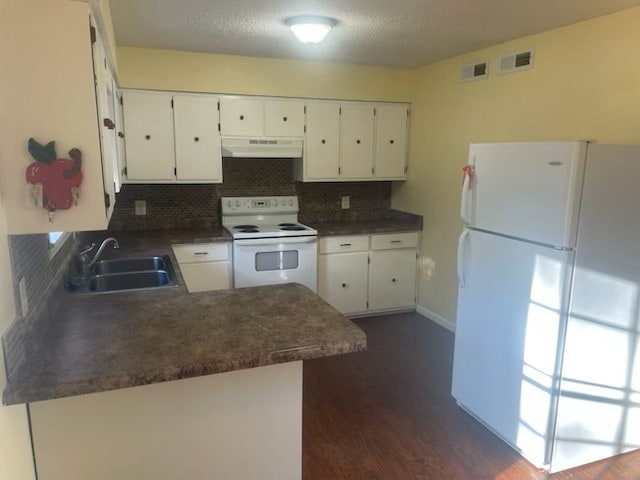 kitchen featuring white appliances, backsplash, sink, and white cabinetry