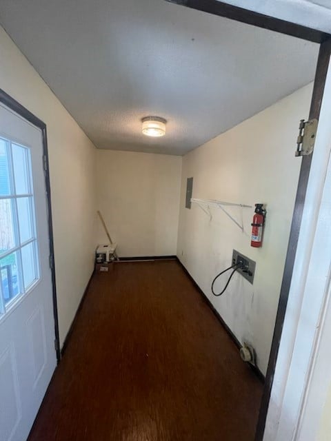 clothes washing area featuring electric panel, hookup for a washing machine, and dark wood-type flooring