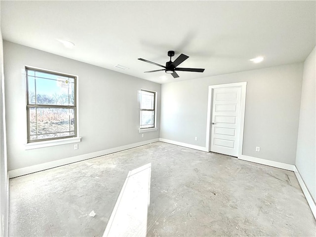 empty room with a wealth of natural light and ceiling fan