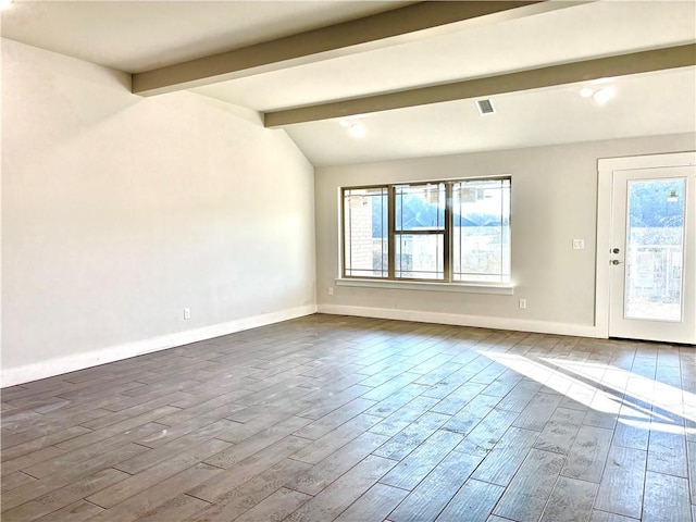 spare room with hardwood / wood-style floors and lofted ceiling with beams