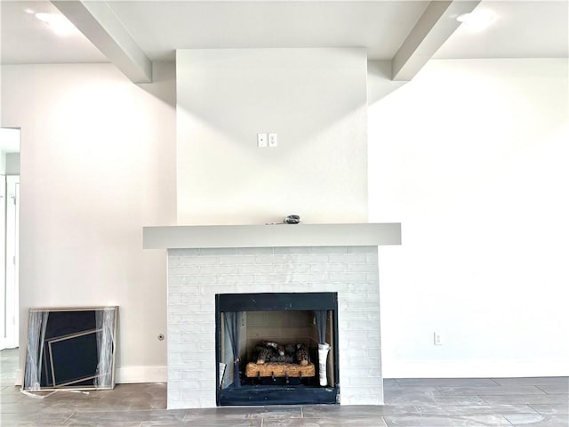 details with beamed ceiling and a fireplace