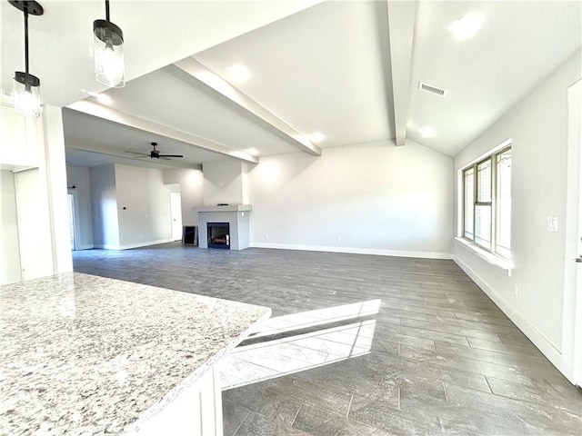 living room featuring lofted ceiling with beams, ceiling fan, and dark wood-type flooring