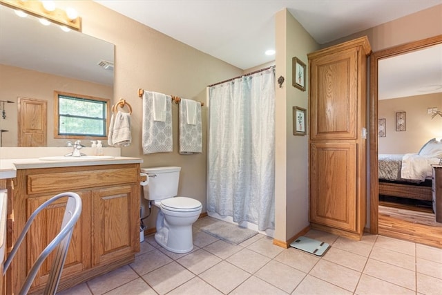 bathroom featuring vanity, toilet, and tile patterned floors