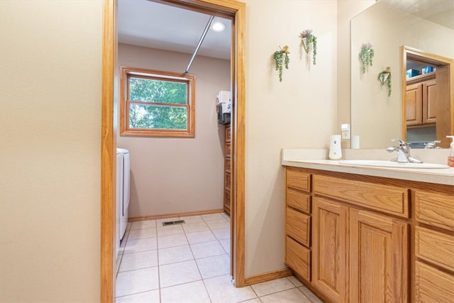 bathroom featuring vanity, tile patterned flooring, and washing machine and clothes dryer