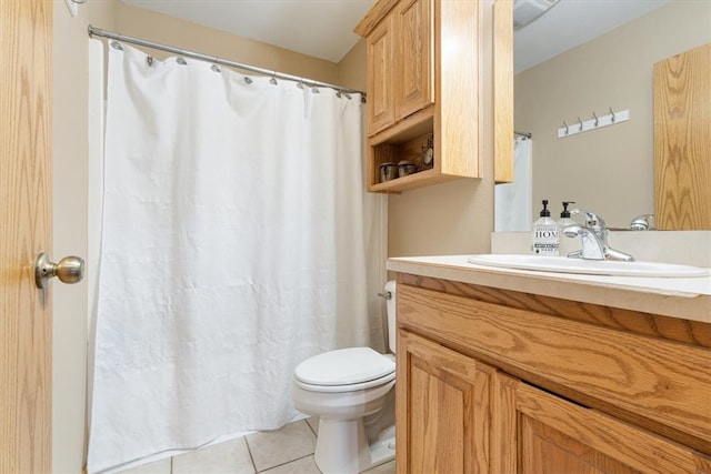 bathroom featuring toilet, tile patterned flooring, vanity, and walk in shower