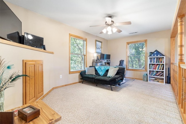 carpeted living room featuring a wealth of natural light and ceiling fan