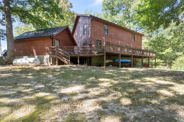 back of house featuring a deck and a lawn