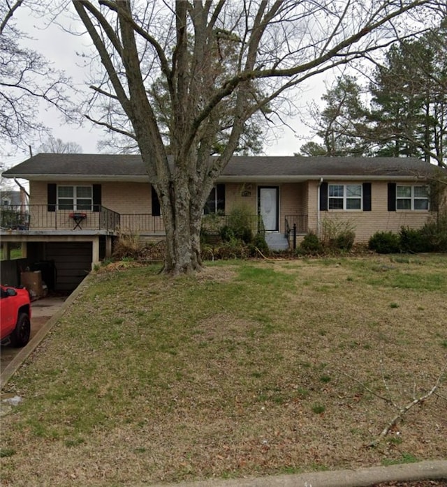 ranch-style house featuring a deck and a front lawn